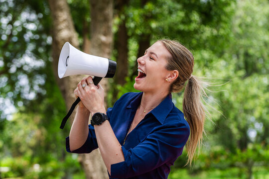 Communication concept megaphone held by speech pathologist shouting outdoors