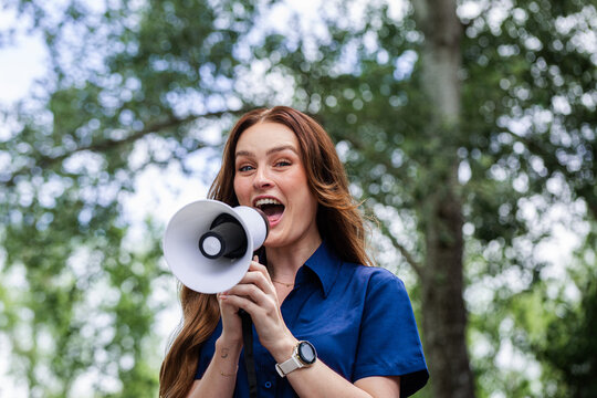 Communication concept megaphone held by speech pathologist shouting outdoors
