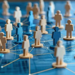 A vibrant network of wooden figures symbolizes social connections and collaboration on a blue backdrop, representing community and interaction.