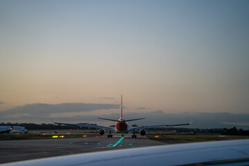 on a plane looking over the wing at sunset