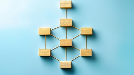 A minimalist diagram with wooden blocks connected by lines, forming a network on a blue background, representing organization or system design.