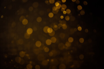 Blurred photo with golden dots visible glittering, shining brightly look and feel luxurious Suitable for use as a wallpaper