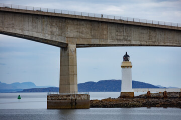 Unique lighthouse and bridge view at Isle of Skye, Scotland during a calm day