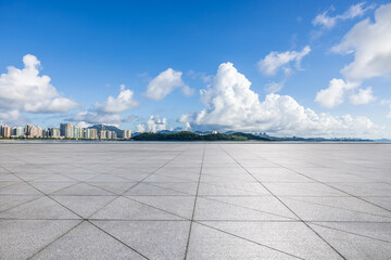 Empty square floor and island with modern building scenery under blue sky. Outdoor natural background.