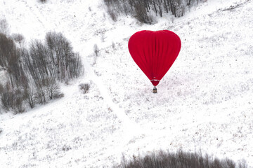A heart-shaped hot air balloon on the winter field
