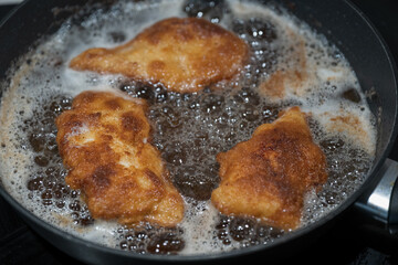 Frying chicken cutlets in a pan.
