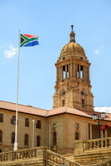 The South African flag with the Union Buildings in the background