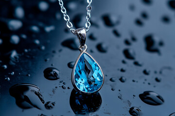 Silver Chain Necklace with Teardrop Blue Topaz Pendant on Wet Surface