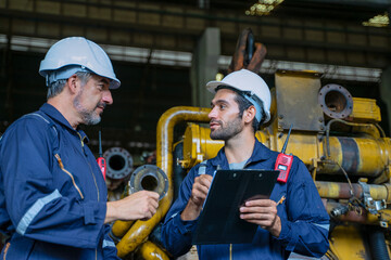 Technicians work at train engine repair shop.