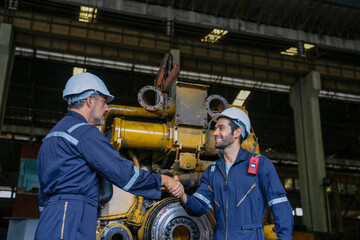 Technicians work at train engine repair shop.