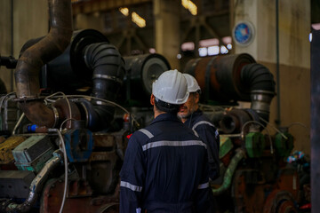 Technicians work at train engine repair shop.