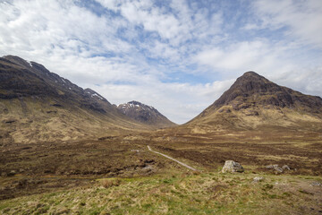 Explore the breathtaking landscape of Glencoe in Scotland, highlighting the valley and mountains under a cloudy sky