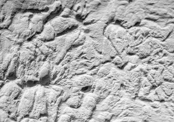 Sliding stone plaster in the image of a lifeless cold desert in the form of abstraction
