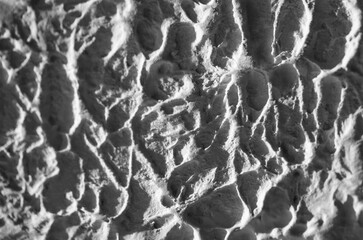 Sliding stone plaster in the image of a lifeless cold desert in the form of abstraction