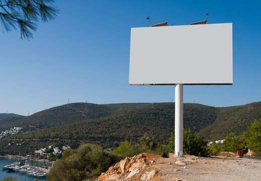Empty billboard for outdoor advertising banner. Large billboard on the road to luxury holiday resort