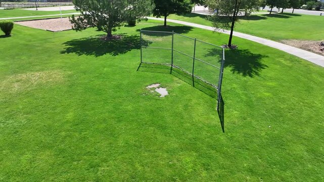 A boomerang view of the fence at a baseball and softball field in a city park.