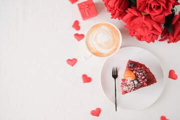 red velvet cake with fruit and coffee for valentines day on white table setting, copy space