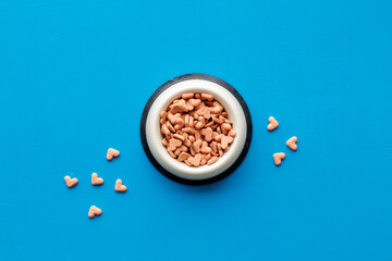 Food and treats for pets - biscuits in a shape of heart in a bowl
