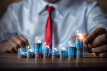 Businessman putting down money, pointing with pen and showing candlestick symbol for investing,...