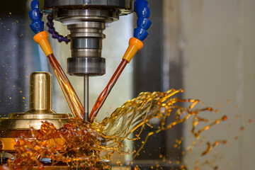 The CNC milling machine cutting the shell mold parts with oil coolant method. © Pixel_B