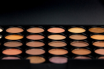 Assorted eyeshadow palette showcasing a variety of neutral shades for makeup application in beauty routines
