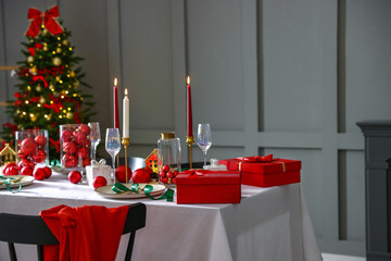 Christmas celebration. Festive table setting with dishware, glasses and decor