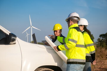 Engineers brainstorm on a plan to inspect the performance of wind turbines in the field using a...