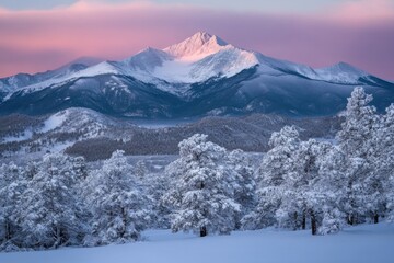 Obraz premium Snow-covered mountains with pink skies at dawn in a winter landscape