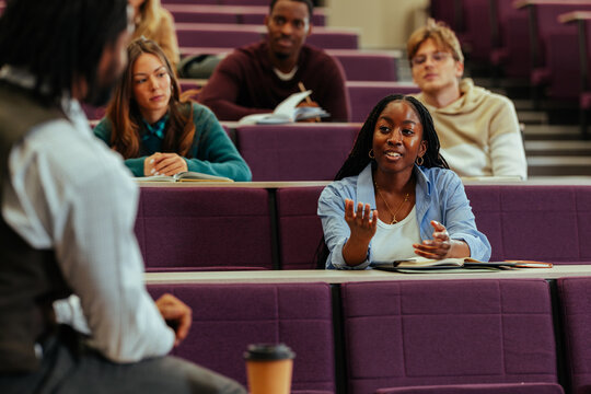 University student asking question during lesson in lecture hall