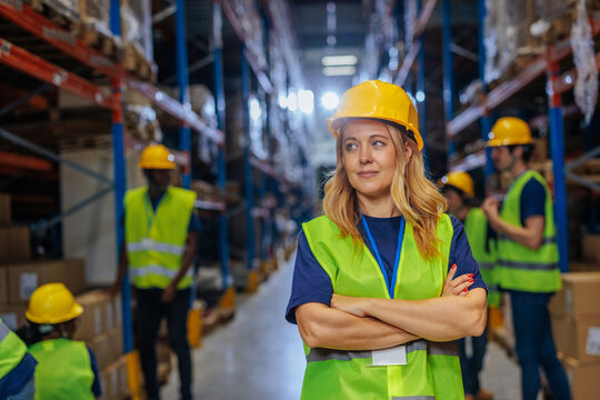 Confident female warehouse worker in safety gear