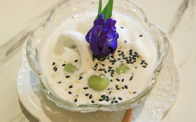 Tasty glutinous rice ball dumpling with shredded coconut fillings in coconut milk called Khanom Kho Kati