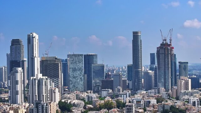 A stunning aerial drone view of Tel Aviv, Israel, showcasing its modern skyline, Mediterranean coastline, and vibrant urban landscape. Capturing the dynamic energy of the city from above.

