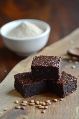 Three rich chocolate brownies stacked with scoop of flour, ideal for dessert inspiration and culinary blog content.