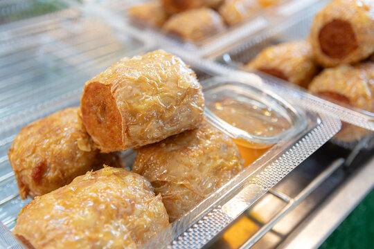 Fried crab meat rolls or hoi jo in plastic box, Chinese food.