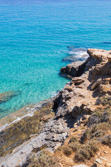 Crystal Clear Turquoise Sea Waters Along the Rocky Coastline at Summer Day