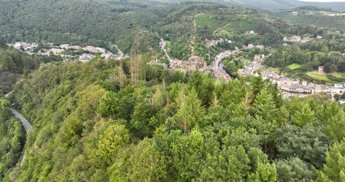 La roche en ardenne from above with a river, and forested hills surrounding on sunny day in Belgium
