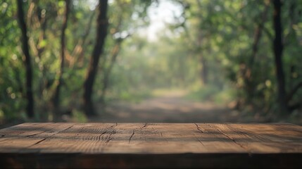 Fototapeta premium Wood table top in front of of trees in the forest. blur background image, for product display montage