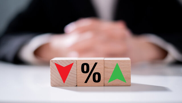 Income debt interest percent inflation with increase and decrease icon on wooden block finance business economy investment concept