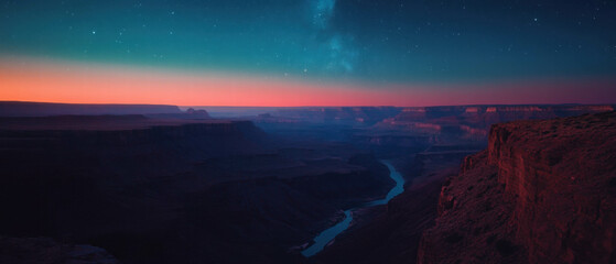 Night sky over a vast canyon illuminated by countless stars and a soft glow on the horizon