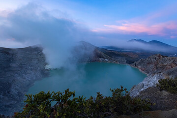 Sulfur smoke rising from Ijen crater over acid lake in Java island Indonesia