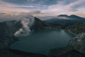 Sulfur smoke rising from Ijen crater over acid lake in Java island Indonesia