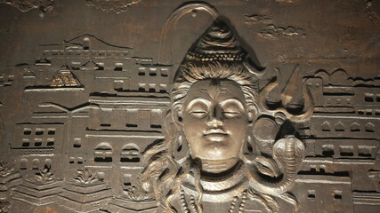 Intricate wall carving of indian god shiva face in banaras