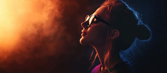 Profile of a woman wearing glasses in a studio with dramatic light spots and colorful fog against a dark background, side view portrait photography.