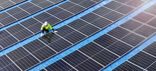 Engineer inspecting solar panels on a rooftop photovoltaic system ensuring clean energy generation...