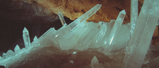 Majestic underground cave with sparkling crystal formations illuminated by natural light