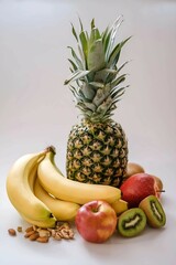 Pineapple, banana, apple and kiwi on a white background