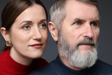 Fototapeta premium Daughter and her father on dark background, closeup