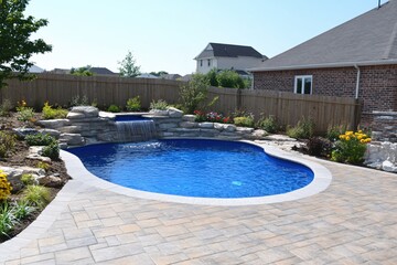 Serene Backyard Oasis with Inground Pool and Natural Stone Waterfall Feature