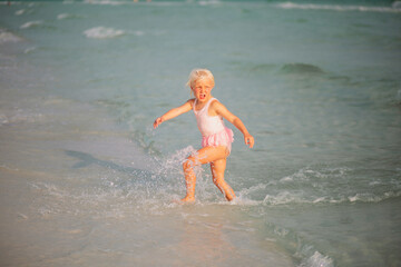 little girl running on the beach