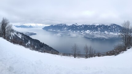 Obraz premium Panoramic Winter View of Snow-Covered Mountains and Misty Lake in Switzerland